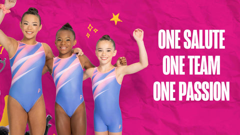 Three young gymnasts wearing matching blue, pink, and purple striped leotards pose together against a bright pink background with the text 'ONE SOLUTE ONE TEAM ONE PASSION'.
