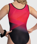 Close-up of geometric prism print and color detail on All Star Prism gymnastics leotard in red & black