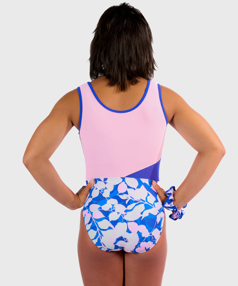 Plum Arctic Rose Leotard with soft pink hues and blue-and-white floral accents, featuring asymmetrical mesh design and smooth seams. Comes with a matching scrunchie. 