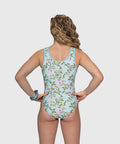 Back view of gymnast in Berry Bliss gymnastics leotard with blue stripe accents and berry floral pattern while training.