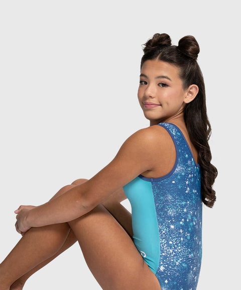 Young girl wearing a blue and turquoise leotard on a white background