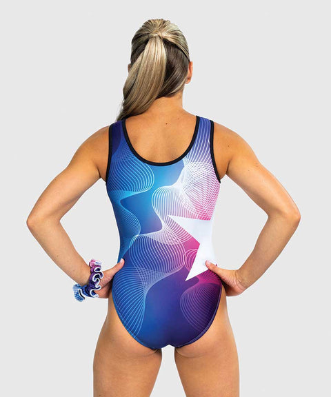 Girls gymnastics leotard with blue-to-pink ombré, white linework, and star graphic. Traditional tank fit.
