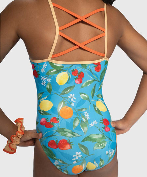 Close-up of citrus fruit print and criss-cross back detail on Citrus Grove gymnastics leotard