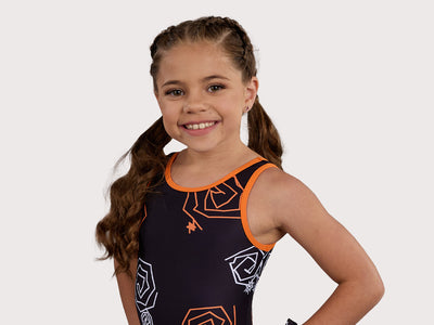 Plum Doodle Gymnastics Unitard for Girls in black, orange, and white. Girls Gymnastics Leotard with Halloween design.