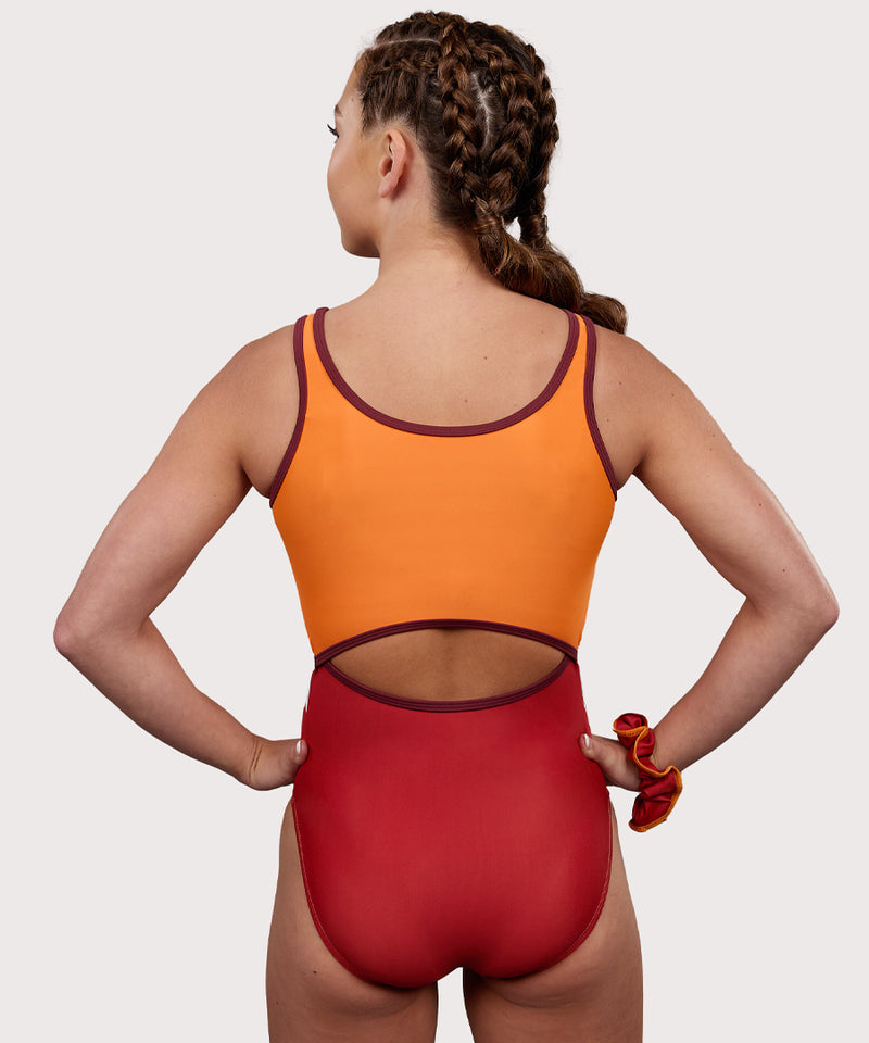 Plum Fawn Keyhole Gymnastics Leotard for Girls in orange, copper, brown, and white. Girls Gymnastics Leotard with wavy design.