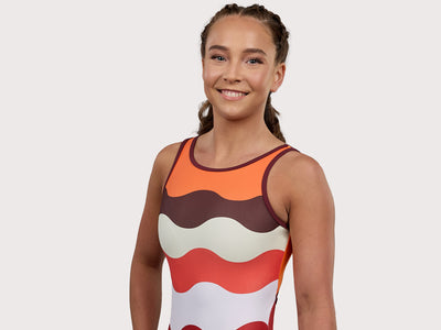 Plum Fawn Keyhole Gymnastics Leotard for Girls in orange, copper, brown, and white. Girls Gymnastics Leotard with wavy design.