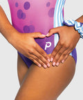 Plum Love - Girls gymnastics leotard with purple-to-pink ombré bubble print and bold stripe side panels.