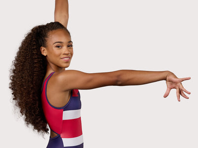 Plum Ivy Keyhole Gymnastics Leotard for Girls in red, white, and blue. Girls Gymnastics Leotard with stripe design.