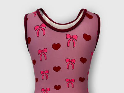 Back of Bow-tiful Valentine leotard with soft blush base and a bold maroon bow graphic.