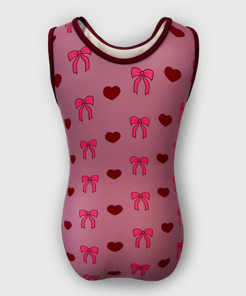 Back of Bow-tiful Valentine leotard with soft blush base and a bold maroon bow graphic.