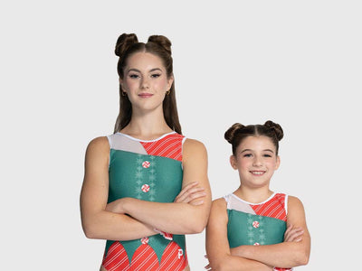 Women and girls gymnastics leotard with candy cane stripe body, green vest overlay, and sheer mesh cutouts.