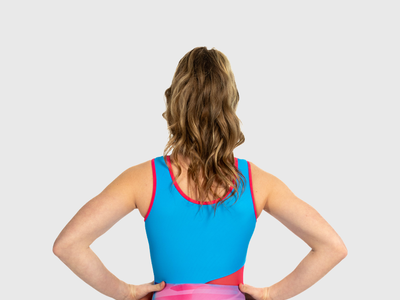 Girls pink, blue and purple swirl gymnastics leotard with diagonal mesh cutout. Lightweight and airy style.