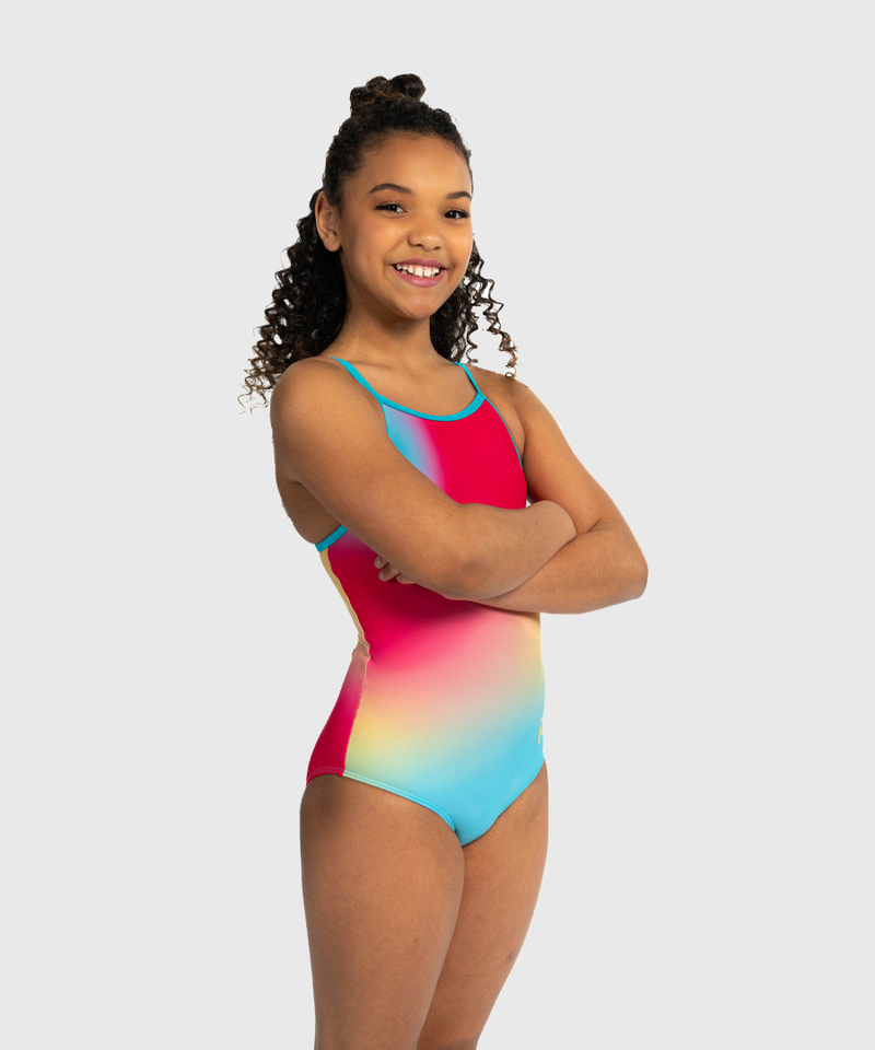 Girls coral shimmer leotard with criss-cross straps. Bold and radiant gymnastics tank.