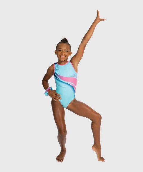 A young girl gymnast posing in a light blue sleeveless leotard with pink and navy diagonal stripes, set against a solid light gray background.