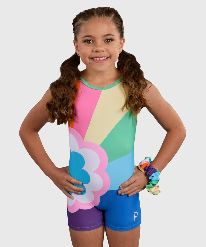 Gymnast wearing the Plum Sprinkles Unitard, a colorful retro gymnastics unitard with a bold rainbow and flower design. 