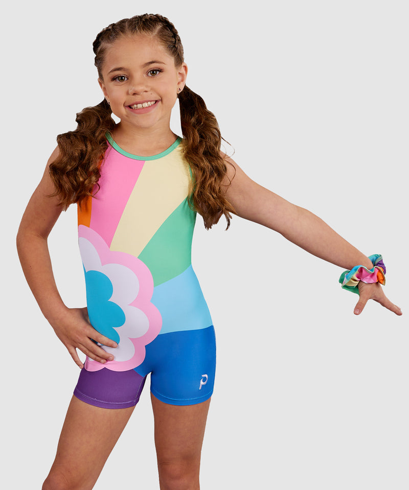 PlumGymnast wearing the Plum Sprinkles Unitard, a colorful retro gymnastics unitard with a bold rainbow and flower design. RePlum Sprinkles Unitard