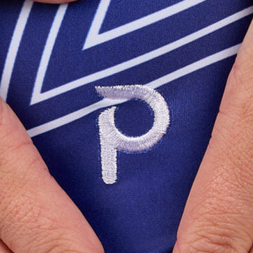 Gymnast wearing the Plum Stellar Mesh Top Leotard with a navy and white star design and breathable mesh panel.