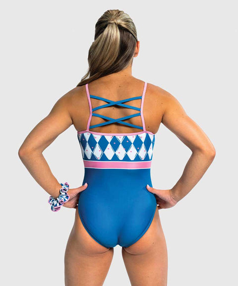 Girls gymnastics leotard with solid blue front and pink-blue harlequin diamond back. Crisscross straps.