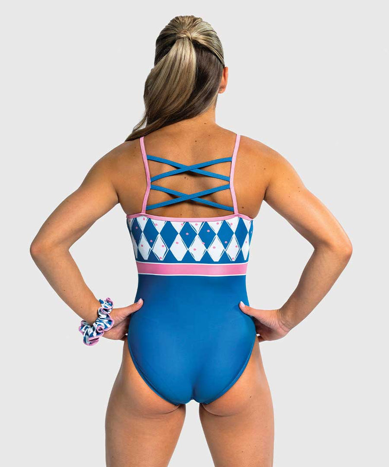 Girls gymnastics leotard with solid blue front and pink-blue harlequin diamond back. Crisscross straps.