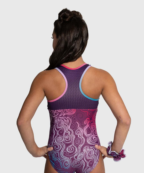 Person wearing a purple and pink patterned leotard on a white background