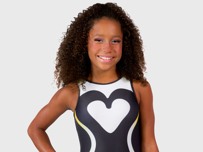 Plum Cares Waddle Wuv Traditional Leotard is with black, silver, and white tones, featuring penguin feather-inspired patterns. 