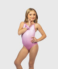 A young girl modeling a shiny light pink one-piece swimsuit with a matching pink wristband, posed against a solid light gray background.