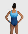 A woman modeling a gymnastics leotard from the back, featuring a light blue to dark blue gradient with a snowflake pattern on the upper back, set against a solid light gray background.