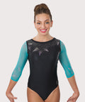 A female model wearing a black and blue gymnastics leotard with rhinestone details and a sea star graphic on the sleeves.